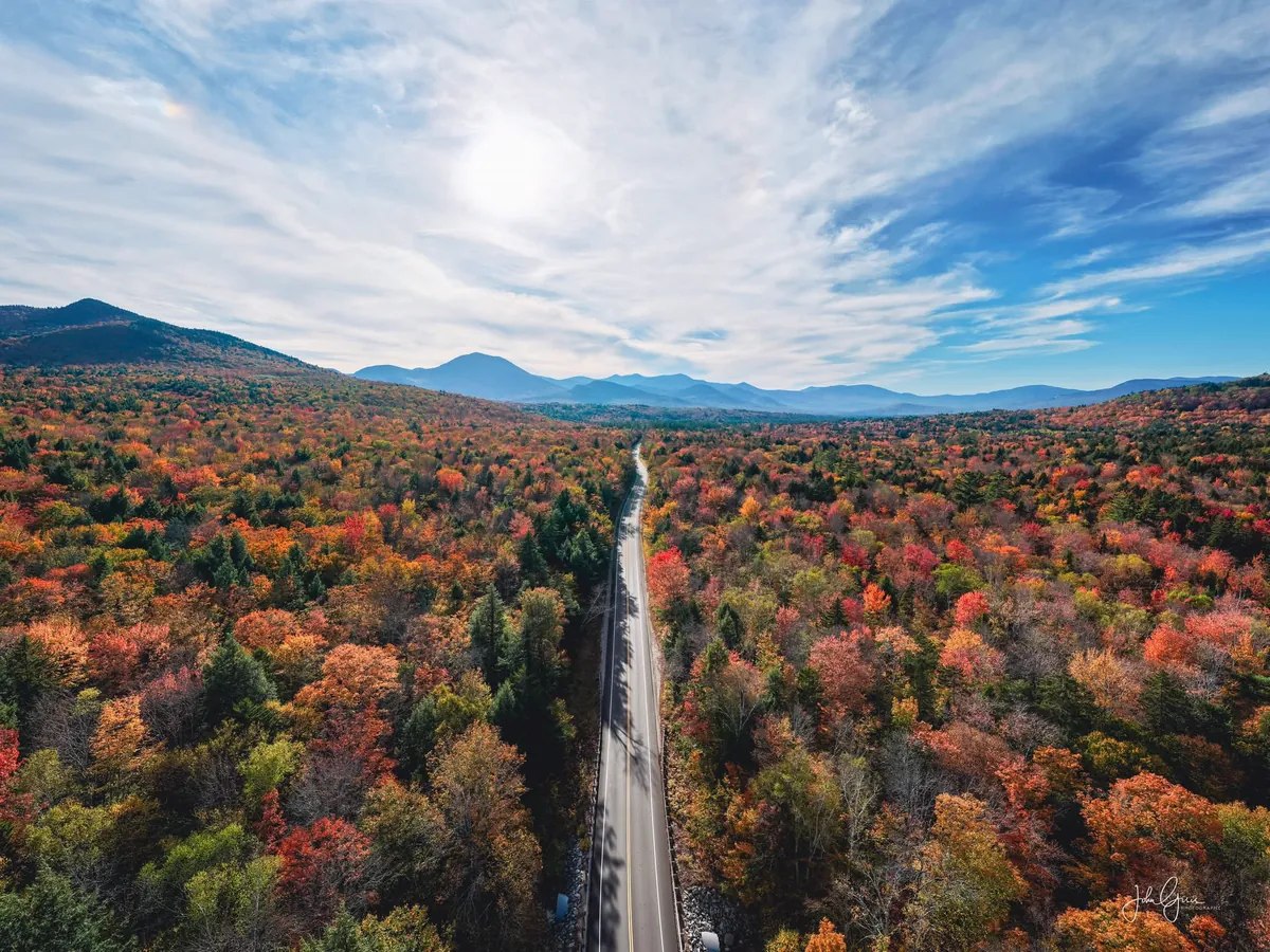 A road winding through New Hampshire fall foliage